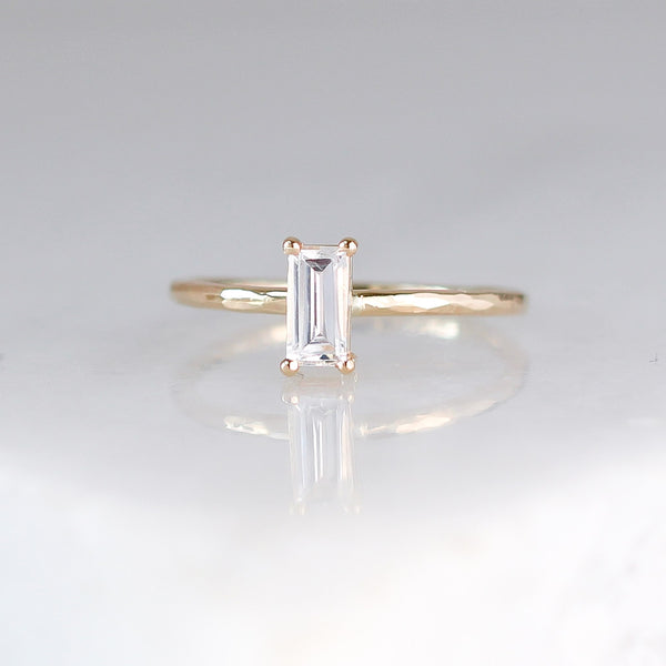 White sapphire ring stacker in yellow gold front view