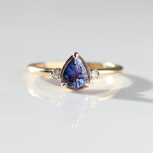 Pear Cut Purple Sapphire ring front view in sunlight with reflections