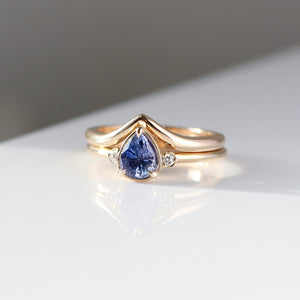 Pear Cut Purple Sapphire ring stacked with wave gold band front view