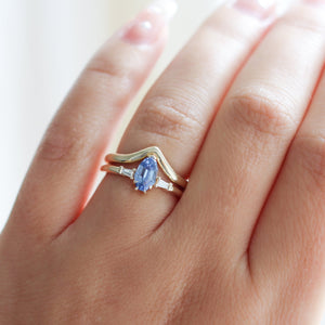 Shield Cut Blue Sapphire Ring with gold wave band on hand