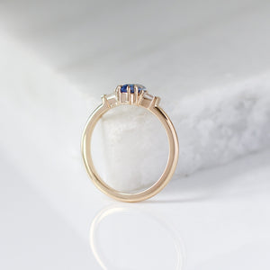 Shield Cut Blue Sapphire Ring profile view on marble 