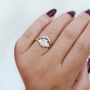 Emerald Cut Lab Diamond Ring paired with diamond wave band worn on hand close up