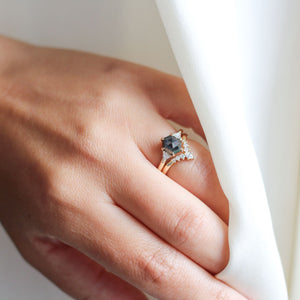 Hexagon Cut Black Diamond Ring paired with crown diamond band on hand in sunlight 