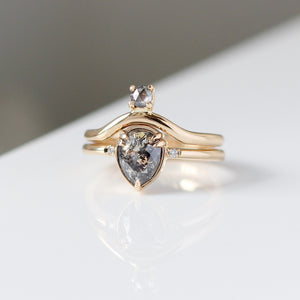 Pear Cut Salt & Pepper Diamond Ring paired with round diamond gold band in quarter front vew