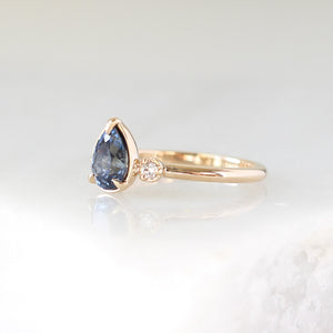 Pear blue sapphire engagement ring side view