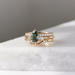 Pear cut green sapphire engagement ring with diamond bands