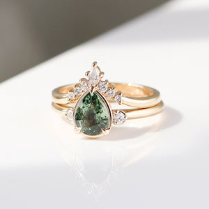 Pear cut green sapphire engagement ring with diamond contour band