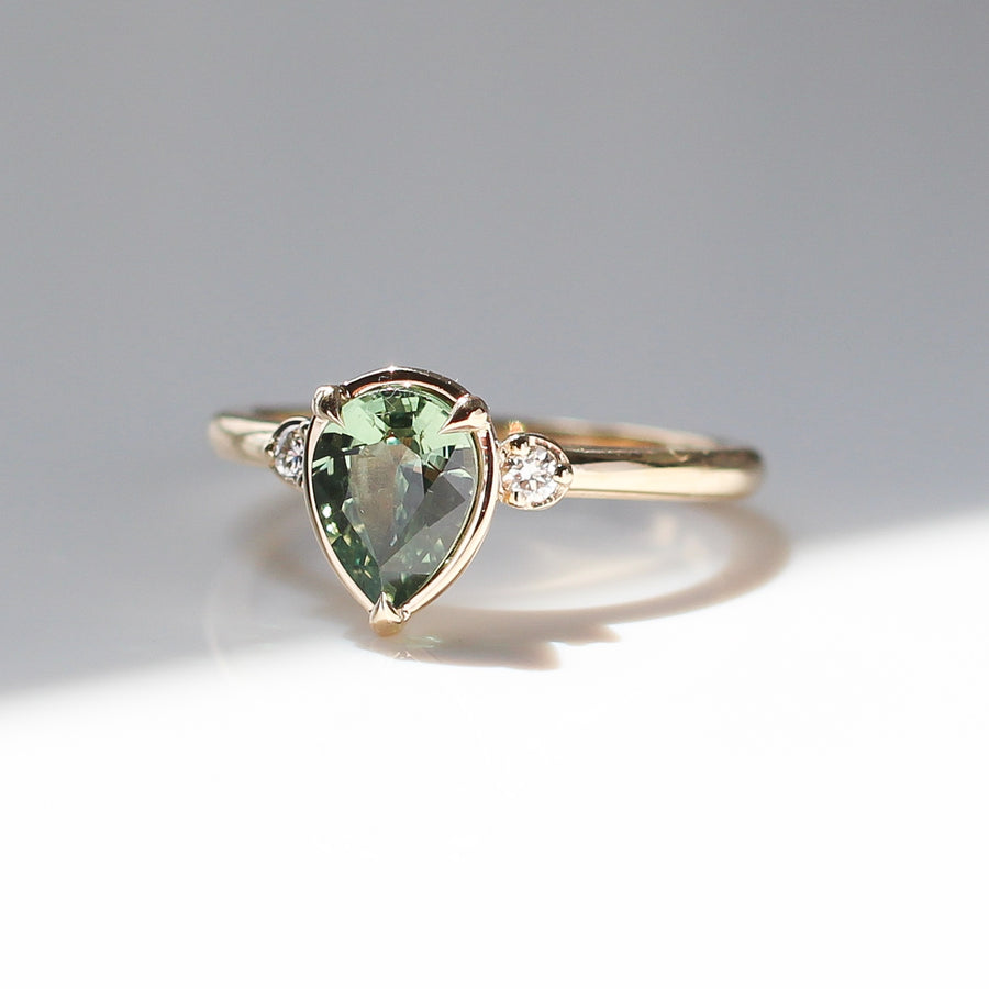 Pear cut green sapphire engagement ring