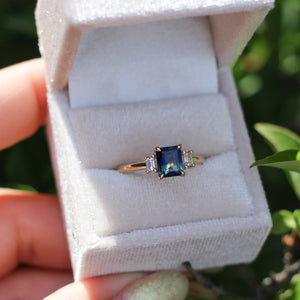 Emerald cut blue sapphire ring in the ring box