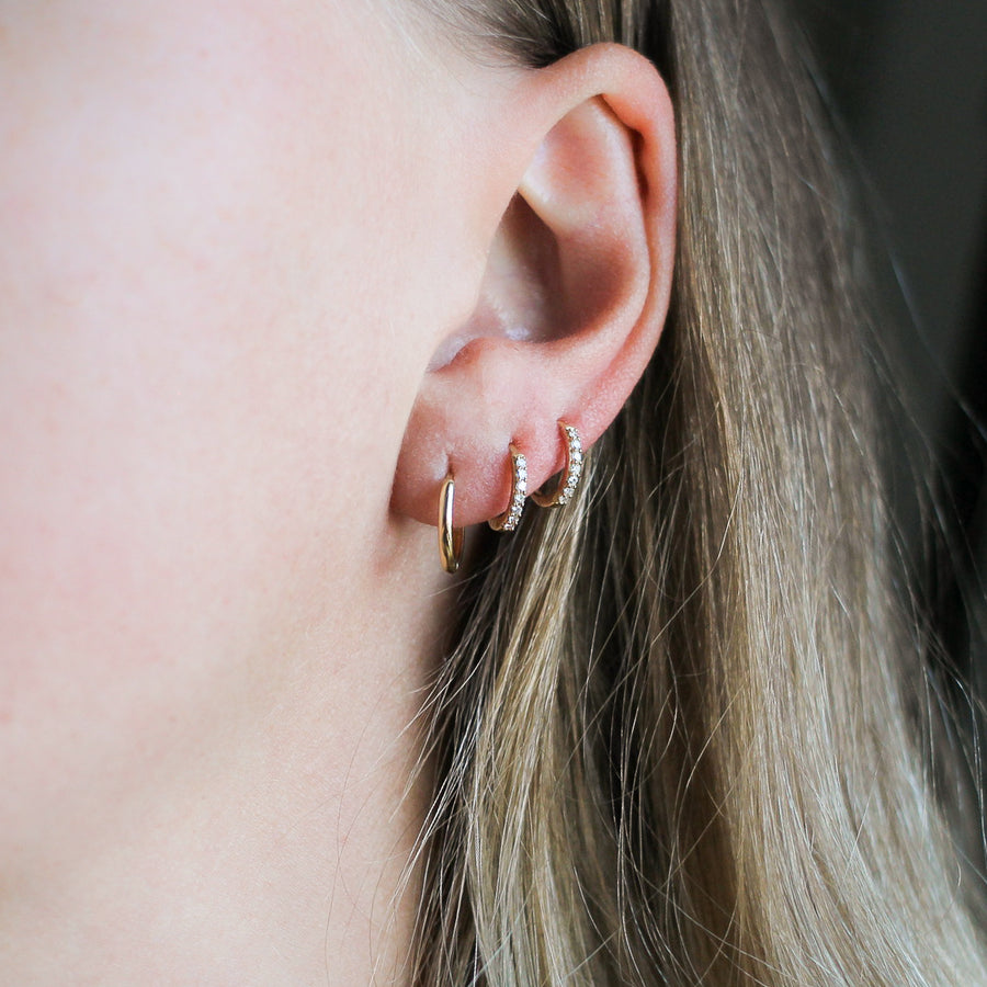 Smooth Hoops in Yellow Gold side and top view over marble